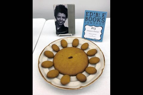 Several cookies and a single raisin represent Lorraine Hansberry's play, "A Raisin in the Sun." 