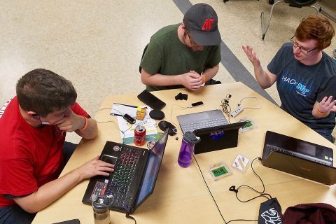 From the left, Nathan Nickelson, Dylan Engle and Aidan Murphy work on their hack, “LeapLearning: Sign Language.” From the left, Nathan Nickelson, Dylan Engle and Aidan Murphy work on their hack, “LeapLearning: Sign Language.”