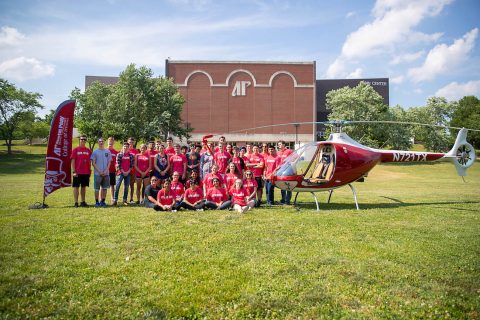 The Governor's School for Computational Physics students stand near one of Austin Peay State University's helicopters. (APSU)