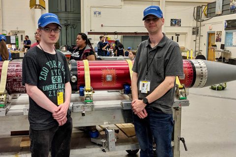 Austin Peay State University students Zach Hill (L) and Zach Givens (R) pose with the rocket that will carry their experiment to space. (APSU)