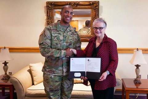 Staff Sgt. Michael Howard, APSU military science instructor and Army National Guard recruiter, and Austin Peay State University President Dr. Alisa White hold the Tennessee STRONG Act deferment agreement. (APSU)