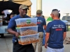 A volunteer from the Combined Joint Forces Land Component Command -- Operation Inherent Resolve, carries food that will be used in support of the Independence Day celebration sponsored by the USO and held at the former Erbil International Airport, Erbil Iraq, July 4, 2016. The event was held for all U.S. and Coalition service members in Erbil and included a variety of food and drink, games, and live music provided by the 101st Airborne Division (Air Assault) group, The Other Guys, and a raffle sponsored by the USO and other organizations. (U.S. Army Photo by Maj. Allen Hill/Released)
