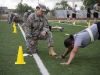 Staff Sgt. Rebecca Reeves, from the Division Signal Company, Headquarters and Headquarters Battalion, 101st Airborne Division (Air Assault), grades Sgt. Vimarie Pedro, from the 101st Combat Aviation Brigade, 101st Abn. Div., on the pushup event during the Army Physical Fitness Test, April 21, 2015, during the divisionâ??s noncommissioned officer and Soldier of the year competition held here. Competitors from 2nd Brigade Combat Team and 3rd BCT would ultimately take home the titles after three days of events. (U.S. Army photo by Staff Sgt. Terrance D. Rhodes, 101st Airborne Division (Air Assault) Public Affairs)