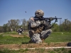 Sgt. Nathan Joachim, Company D, 1st Brigade Combat Team, 101st Airborne Division (Air Assault), fires his M4 rifle while in the kneeling unsupported firing position on a range here during the divisionâ??s 2015 Soldier and noncommissioned officer of the year April 23, 2015. Joachim, is a native of Katy, Texas. (U.S. Army photo Staff Sgt. Terrance D. Rhodes, 101st Airborne Division (Air Assault) Public Affairs)