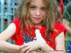 A young girl holds a baby chick at the petting zoo during the 2009 Kiwanis Club Rodeo