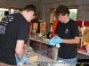Volunteers wrapping hotdogs at the concession stand