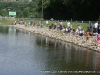 Parents and their children line the shore at the Fairgrounds Pond