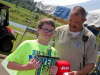 Ethan Duffie caught this year's Smallest Fish, .03 ounces, here he accepts his trophy from TWRA's Jereme Odom
