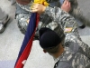 Command Sgt. Maj. Gregory Patton (Left) & Col. Viet Luong (Right), case the brigade colors.