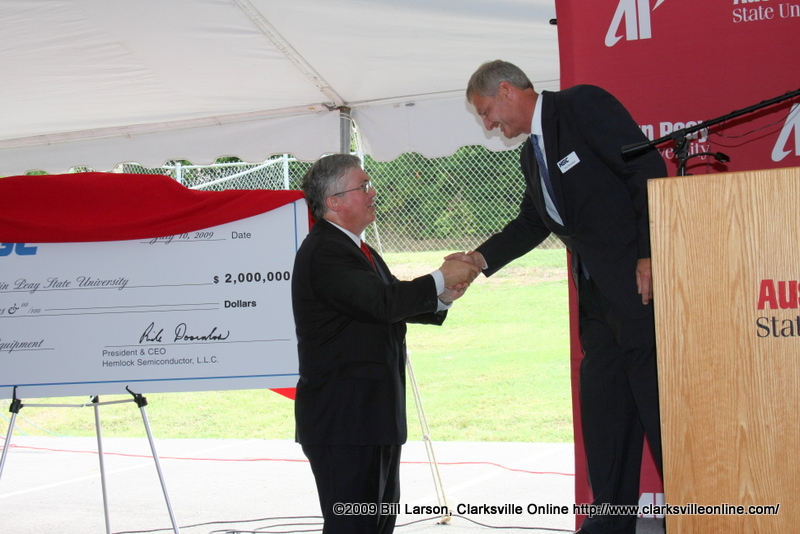President Tim Hall shakes hands with Hemlock Semiconductor LLC President and CEO Rick Doornbos after the University was presented with a 2 million dollar donation. President Tim Hall shakes hands with Hemlock Semiconductor LLC President and CEO Rick Doornbos after the University was presented with a 2 million dollar donation.