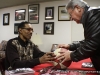 Fly Williams inspecting a basketball he signed while an APSU student.