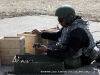 A soldier sorts the spent rounds