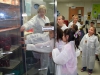 Blanchfield Army Community Hospital's supervisor of microbiology Annie Baker shows gifted students from Barsanti Elementary School how empty bacterial culture plates  are stored in a laboratory refrigerator Nov. 19, 2013 at Fort Campbell, Ky. (U.S. Army photo by Laura Boyd/RELEASED)