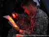 In the declining light one of the helicopter crewmembers looks at the map of the exercise locations