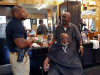 Clarksville Police Department visit with people at Keesee Barbershop during their third "Chat and a Cut" community outreach event.