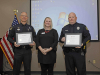 Red Cross' Katy Hagstrom gives Donald Gipson and Darren Koski the Red Cross Extraordinary Personal Action Certificate.