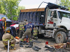 Clarksville emergency crews work to free Scott Flitsch's leg from underneath a dump truck. (Jim Knoll, Clarksville Police Department)