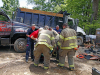 Clarksville emergency crews work to free Scott Flitsch's leg from underneath a dump truck. (Jim Knoll, Clarksville Police Department)