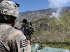 U.S. Army Pfc. Claudio J. Wilson of Brooklyn, NY, a grenadier with 1st Platoon, Company A, 1st Battalion, 327th Infantry Regiment, Task Force Bulldog, scans a nearby ridgeline at a mountaintop observation post in eastern Afghanistan’s Kunar Province Sept. 21st as mortar shells rain down against an enemy sniper. (Photo by U.S. Army Staff Sgt. Gary A. Witte, 300th Mobile Public Affairs Detachment)