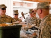 Soldiers from Company B, 1st Battalion, 506th Infantry Regiment, 4th Brigade Combat Team, 101st Airborne Division deployed to Combat Outpost Sar Howza, Paktika Province, Afghanistan, are served lunch by U.S. Army Lt. Col. David Preston, 801st Brigade Support Battalion commander, 4th Brigade Combat Team, 101st Airborne Division, Task Force Currahee, from Belchertown, MA, July 18th as a morale boost eight days after the loss of one of their own, Spc. Rafael Nieves. (Photo by U.S. Army Sgt. Charles Crail, Task Force Blackhawk Public Affairs)