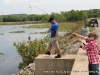 In no time, Garrett Snider has reeled in a small blue gill.