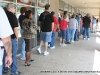 Approximately 100 people stand in line waiting to vote.