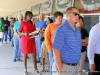 Approximately 100 people stand in line waiting to vote.