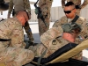 Spc. Mark E. Faucette (left), a native of Sellersville, Pa., and Spc. David C. Choeun (right), a native of San Bernardino, Calif., straps up Spc. Daniel O. Paul (middle), a native of Americus, Ga., onto a litter during aeromedical evacuation training, Aug. 22, 2013 at Bagram Air Field, Parwan province, Afghanistan. (U.S. Army photo by Sgt. Sinthia Rosario, Task Force Lifeliner Public Affairs)