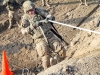 Spc. James Craig, an air defense battle management system operator assigned to Headquarters, Headquarters Company, 3rd Brigade Combat Team “Rakkasans,” 101st Airborne Division (Air Assault), uses a rope to pull himself over a large dirt wall in the obstacle course portion of the brigade noncommissioned officer and Soldier of the quarter competition on Forward Operating Base Salerno, Afghanistan, Feb. 15, 2013. The competition included a five-mile march and five different combat related stations throughout the competition. (U.S. Army photo by Spc. Brian Smith-Dutton, Task Force 3/101 Public Affairs) 