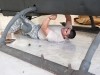 Spc. Abraham Feria, B Company, 96th Aviation Support Battalion, 101st Airborne Division (Air Assault,) OH-58D electronics, avionics and armament technician, installs rivets into the undercarriage of an AH-1F Cobra helicopter  in the final stages of restoration at Fort Campbell, Ky., August 19, 2013. (U.S. Army photo by Sgt. Duncan Brennan, 101st CAB Public Affairs)