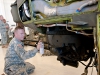 Sgt. Steven Gould, B Company, 96th Aviation Support Battalion, 101st Airborne Division (Air Assault,) paints the mount of the 20mm gun during the restoration of an AH-1F Cobra Helicopter at Fort Campbell, Ky., August 8, 2013. (U.S. Army photo by Sgt. Duncan Brennan, 101st CAB Public Affairs)