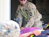 U.S. Army Pfc. Katie Dove, a combat medic with Charlie Company, 801st Brigade Support Battalion, 4th Brigade Combat Team, 101st Airborne Division, assists in the loading of a simulated casualty during a mass casualty exercise at Forward Operating Base Salerno, Khost province, Afghanistan, August 6, 2013. The simulated casualty is taken from the casualty collection point vicinity of the point of injury to the nearby medical treatment facility for follow on triage and treatment. (U.S. Army photo by Maj. Kamil Sztalkoper/Released)