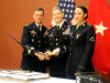 Brig. Gen. Todd Royar, acting senior commander of the 101st Airborne Division, Col. Andras Marton and Pvt. Talia Faircloth, Office of the Staff Judge Advocate, Headquarters Support Company, Headquarters and Headquarters Battalion, 101st Airborne Division (Air Assault) pose for a photo during a cake cutting ceremony at Cole Park Commons Conference Center on Fort Campbell, Kentucky, July 27. The cake was cut in commemoration of the 243rd anniversary of the United States Army Judge Advocate General’s Corps. (US Army Photo by Pfc. Lynnwood Thomas, 40th Public Affairs Detachment)