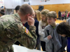 Pfc. Michael Flaugher, Headquarters and Headquarters Company, 129th Division Sustainment Support Battalion, 101st Airborne Division (Air Assault) Sustainment Brigade, shows students of Trigg County Middle School how to operate a military communications system during the school’s career day, Jan. 28, In Cadiz, Ky. (Sgt. Aimee Nordin, 101st Airborne Division (AA) Sustainment Brigade Public Affairs)