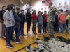 Pfc. Keneth Fouts, 74th Composite Truck Company, 129th Division Sustainment Support Battalion, 101st Airborne Division (Air Assault) Sustainment Brigade, shows students of Trigg County Middle School the different type of gear that 101st Airborne Division Soldiers wear such as wet weather gear, cold weather gear and operational camouflage pattern uniforms, Jan 28, in Cadiz, Ky. (Sgt. Aimee Nordin, 101st Airborne Division (AA) Sustainment Brigade Public Affairs)