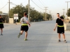 Capt. Eric F. Prazinko, a native of Ozark, AL, and commander of the 101st Special Troops Battalion, 101st Sustainment Brigade, 101st Airborne Division (Air Assault), shouts out the run time to 1st Lt. Timothy S. Ladwig, a native of Minocqua, Wis., and battle captain with Task Force Lifeliner, who was the first runner to complete the 3 mile run in the 101st Special Troops Battalion Iron Dawg competition, Sept. 28, 2013, at Bagram Air Field, Parwan province, Afghanistan. (U.S. Army photo by Sgt. Sinthia Rosario, Task Force Lifeliner Public Affairs)