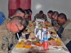 Task Force Lifeliner soldiers bow their heads and give thanks during Thanksgiving Day at the Koele Dining Facility, Nov. 28th, 2013, at Bagram Air Field, Parwan province, Afghanistan. The soldiers had the opportunity to celebrate their holiday with a variety of traditional foods. (U.S. Army photo by Sgt. Sinthia Rosario, Task Force Lifeliner Public Affairs)