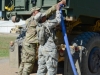 Sgt. Tony Clinton and Spc. Natalie Smith, both water purification specialist with the 129th Combat Sustainment Support Battalion, 101st Airborne Division Sustainment Brigade, 101st Airborne Division (Air Assault), hook a hose onto a Load Handling System Compatible Water Tank Rack, also called a hippo, to fill it with water that was purified through the tactical water purification system Sept. 3, 2015, at the Joint Readiness Training Center’s Intermediate Staging Base in Alexandria, Louisiana. (Sgt. 1st Class Mary Rose Mittlesteadt, 101st Airborne Division Sustainment Brigade (Lifeliners) Public Affairs)