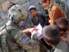 Capt. Louis M. Cascino of Easy Company, 2nd Battalion, 506th Infantry Regiment, 4th Brigade Combat Team, 101st Airborne Division, looks through and reads from a book that a local child showed him while on a patrol in Khowst Province, Afghanistan, on June 2, 2013. (Photo by Sgt. Justin A. Moeller, 4th Brigade Combat Team Public Affairs)