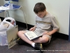 Not waiting to get home, this young man sat down in the floor and began reading one of this new books.