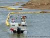 TMS Contracting moving the turbidity barrier from the mouth of the Marina Basin using a Crestliner pontoon boat on loan from Bill Roberts Thunder Road Marina.