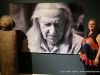 Jerry Church standing next to the portrait of Olen Bryant and one of his sculptures at the Customs House Museum.