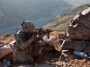 U.S. Army Sgt. Brad R. Allen, an infantry squad leader from Bristol, TN, assigned to Bayonet Company, 2nd Battalion, 327th Infantry Regiment, Task Force No Slack, crouches down and uses his scope to get a better view from his fighting position on a mountainside overlooking the Ganjgal Valley in eastern Afghanistan’s Kunar Province Dec. 11th. (Photo by U.S. Army Staff Sgt. Mark Burrell, Task Force Bastogne Public Affairs)