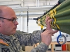 Cpl. Roy Gorris, an aircraft structural mechanic with Company B, 563rd Aviation Support Battalion, 159th Combat Aviation Brigade, paints an OH-23B Raven helicopter March 19 at Fort Campbell, Ky. A team of aircraft structural mechanics has dedicated numerous hours of their free time to rebuild the airframe, which will be displayed outside the 101st Airborne Division\'s Warrior Transition Battalion when it is finished. (U.S. Army photo by Spc. Jennifer Andersson, 159th Combat Aviation Brigade Public Affairs/RELEASED)