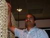 Tandoor owner Hakeem hanging the straw curtains which provide a element of privacy for diners while still allowing them to experience the ambiance of restaurant