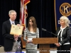 Grace Hinson receives her award and a U.S. flag formerly flown over the U.S. Capitol.