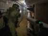 An infantryman with 1st Battalion, 187th Infantry Regiment, 3rd Brigade Combat Team, 101st Airborne Division (Air Assault) fires at notional opposing forces while clearing a tunnel system under the Muscatatuck Urban Training Center at Camp Atterbury, Indiana on Dec. 7, 2018. The tunnel system connected all the buildings. (Sgt. Patrick Kirby, 40th Public Affairs Detachment)