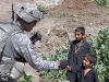 U.S. Army Spc. Robert E. Yates of New Orleans, a team leader with 3rd Platoon, Company D, 1st Battalion, 327th Infantry Regiment, Task Force Bulldog, gives a fist bump to a youth in Samatan village in eastern Afghanistan’s Kunar Province Sept. 24th. (Photo by U.S. Army Staff Sgt. Gary A. Witte, 300th Mobile Public Affairs Detachment)