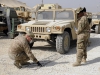 Sgt. Andrew J. Newcomb, a native of Orfordville, Wis., and mechanic shop foreman with Task Force Lifeliner, demonstrates how to properly layout snow chains prior to attaching them on a high mobility multipurpose wheeled vehicle tires as part of winter training class, Oct. 26, 2013, at Bagram Air Field, Parwan province, Afghanistan. This training teaches the soldiers how to properly apply snow chains on tires and how to operate their vehicles in cold weather conditions. (Sgt. Sinthia Rosario, Task Force Lifeliner Public Affairs)