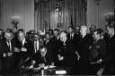 President Lyndon Baines Johnson signing the Civil Rights act of 1964 with Martin Luther King JR observiing